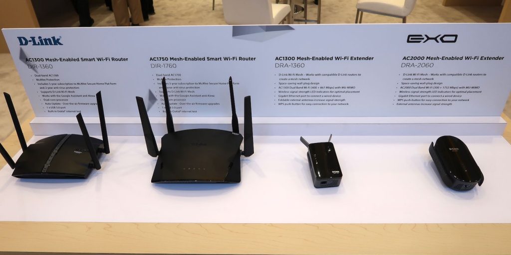  Four D-Link networking devices displayed on a white platform, including two routers and two Wi-Fi extenders, each with descriptions of their features and specifications above them.