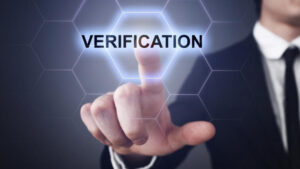 A person in a business suit interacting with a digital interface displaying ‘VERIFICATION’. #ID verification