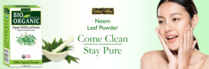 Packaging of Bio Organic Neem Leaf Powder with a bowl of neem leaves and a woman applying the product to her face.