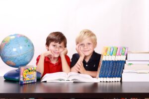 A child practicing spelling words with colorful flashcards and a workbook