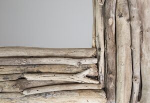 Stack of weathered driftwood pieces showcasing varied textures and tones.