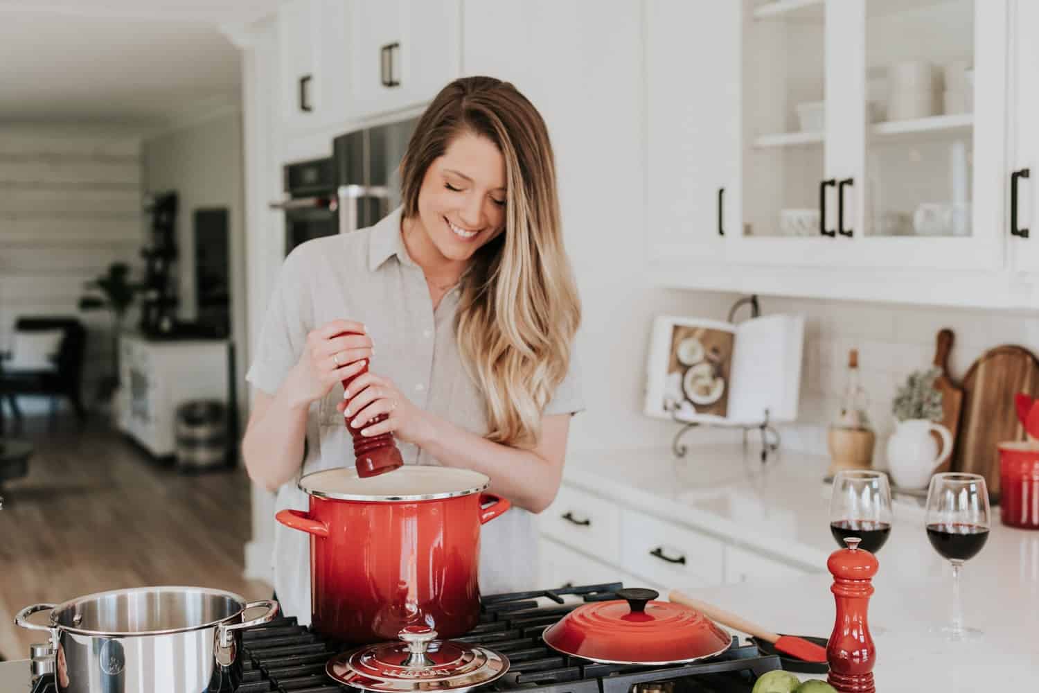 A person cooking in a modern kitchen, potentially indicating daily wear and tear on countertops. #Kitchen countertops