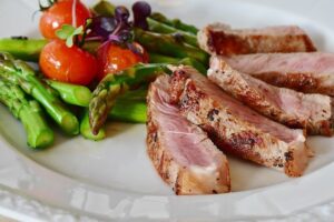 A colorful assortment of healthy foods including vegetables, fruits, nuts, and lean proteins.
