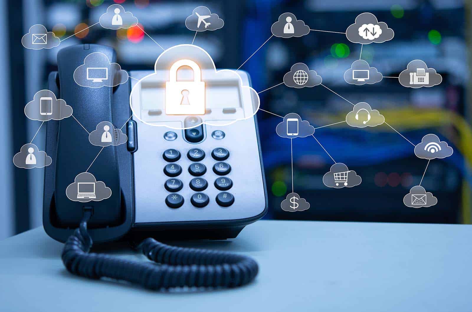 VoIP phone handset next to a laptop displaying a call interface. #VoIP Telephone System