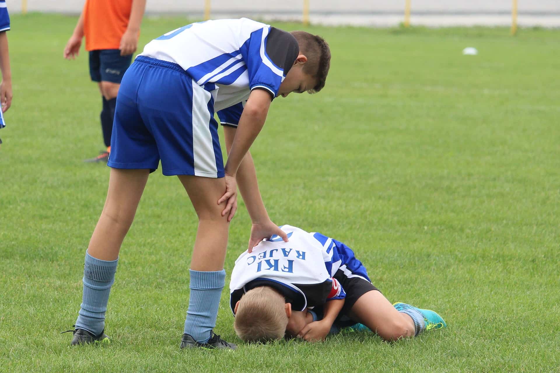 An NFL player being treated for an injury on the field.