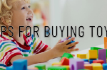 A child at a table playing with colorful building blocks, with text overlay ‘Tips for Buying Toys for Kids'
