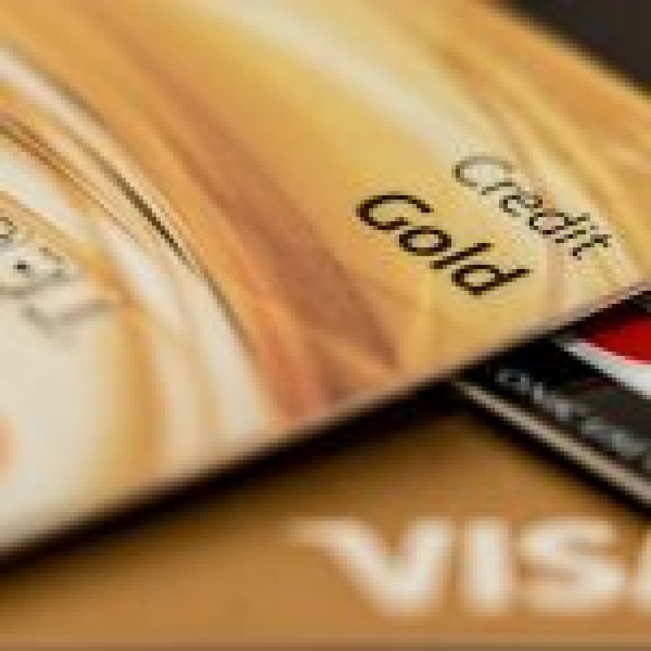 Close-up view of a ‘Credit Gold’ card in front of Visa and MasterCard, symbolising balance transfer options.