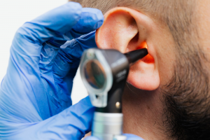 An audiologist conducting a hearing test with a patient using modern audiology equipment.