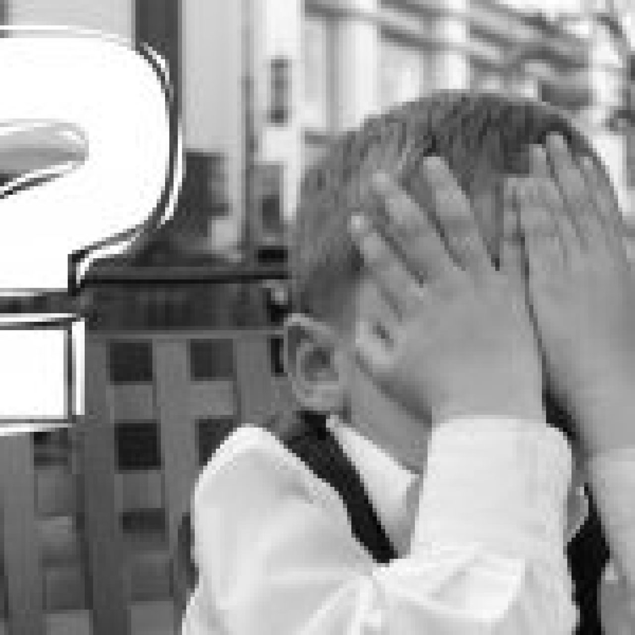 A black and white photo of a child covering their face with hands, flanked by two large question marks, symbolizing the quest for answers in customer engagement.