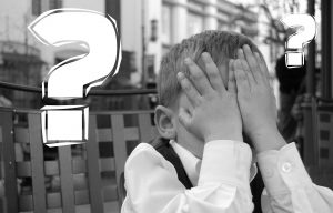 A black and white photo of a child covering their face with hands, flanked by two large question marks, symbolizing the quest for answers in customer engagement.