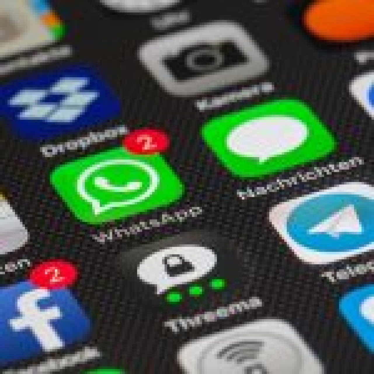 A smartphone screen displaying various social media app icons including WhatsApp, Facebook, Telegram, and others, with notification badges indicating new messages.