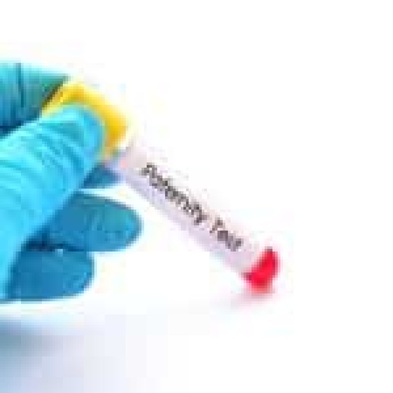 A gloved hand holding a labeled ‘Paternity Test’ tube with a red sample inside against a white background.