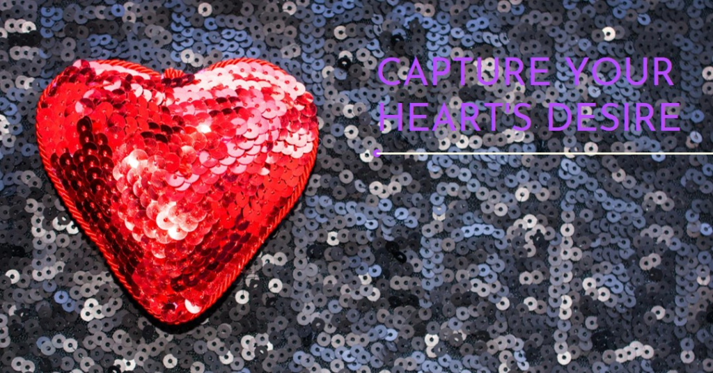 A vibrant red sequined heart stands out against a backdrop of shimmering blue sequins.