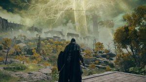 A cloaked figure stands on a ledge overlooking a vast, mystical landscape filled with ruins, golden trees, and a glowing sky in Elden Ring.