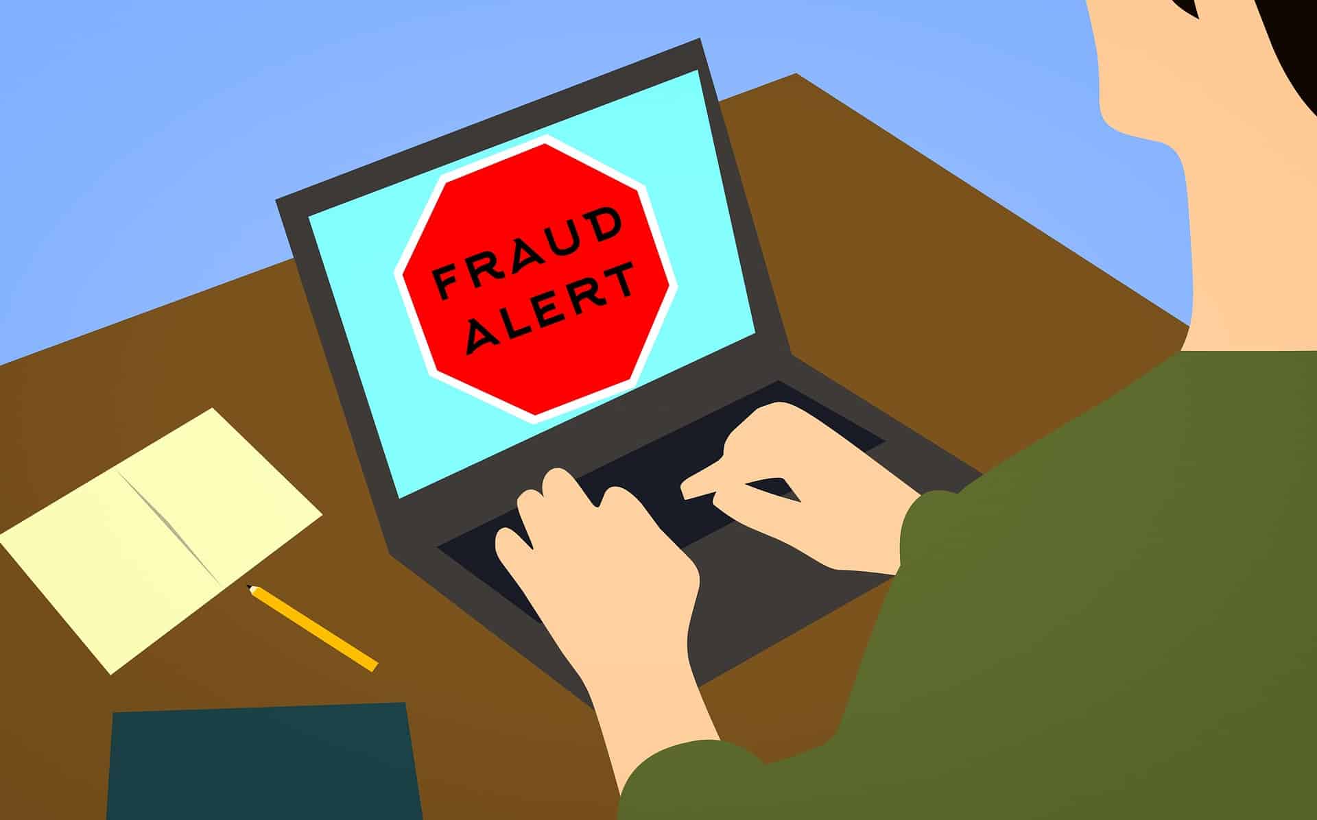 Illustration of a person working on a laptop with a prominent “FRAUD ALERT” warning on the screen, symbolizing e-commerce fraud prevention.