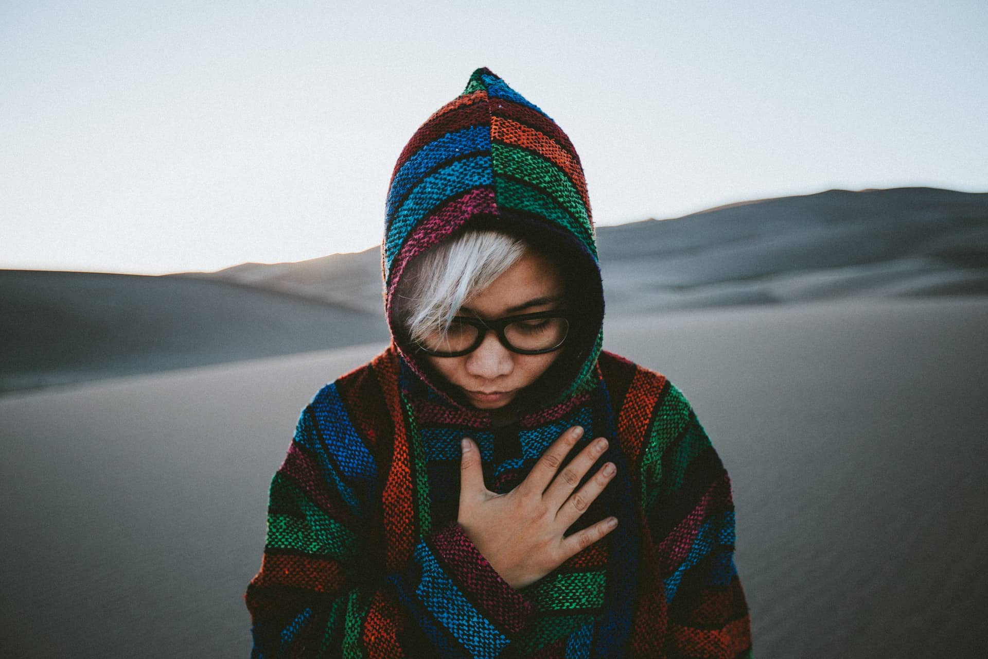 Stylish person wearing a hoodie and shirt, showcasing different ways to style these garments for various events.