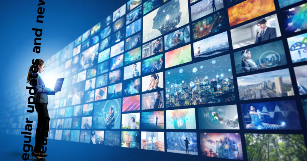 A person stands in front of a large wall of screens displaying various images related to news, business, technology, and global events.