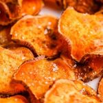 Airfood Recipe : Crispy Airfood Potato Bites In An Air Fryer Basket With Herbs, Garlic, And Paprika On A Rustic Kitchen Counter.