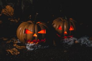 Halloween Horror Nights 2022 with a haunted house and eerie lighting.