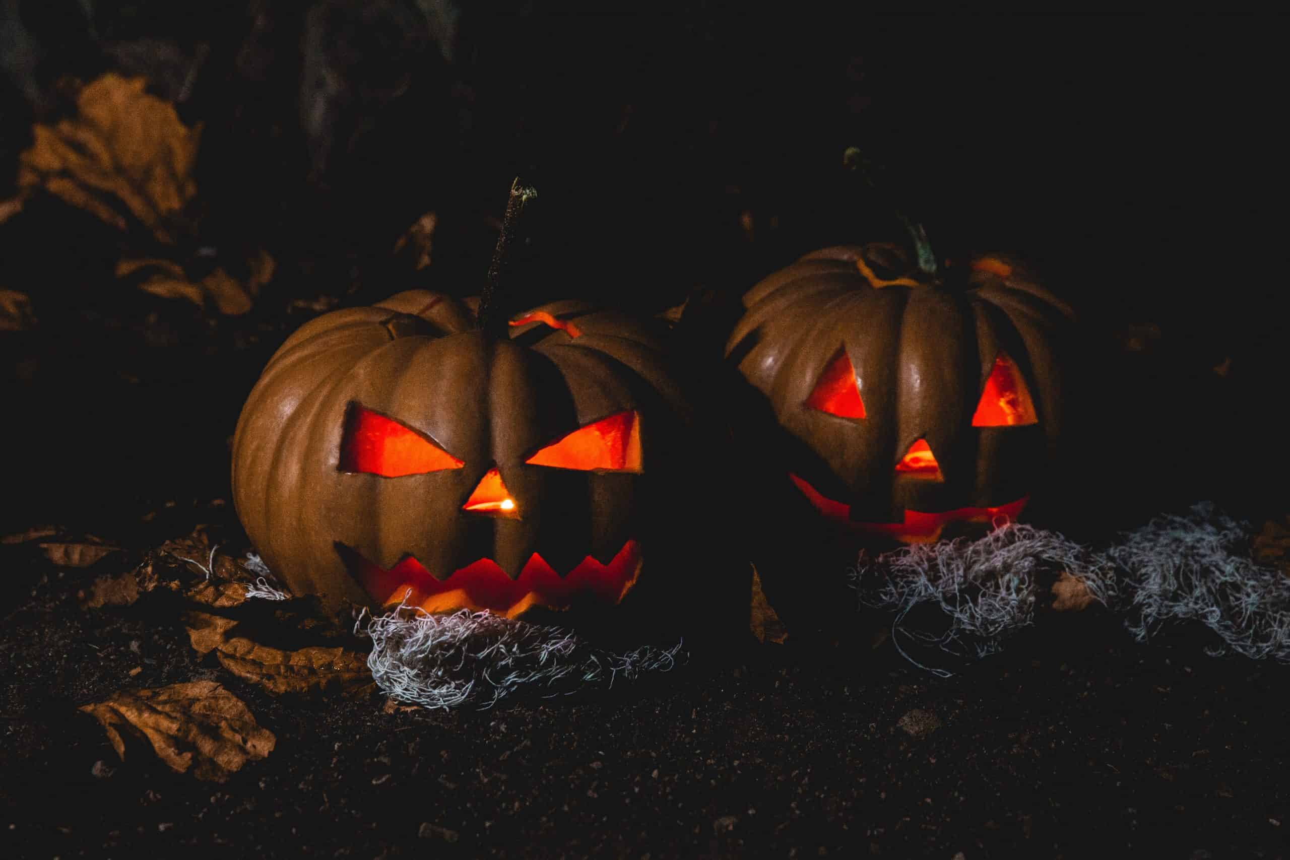 Halloween Horror Nights 2022 with a haunted house and eerie lighting.