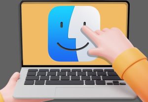 A hand pointing at the Finder icon on a MacBook screen, symbolising essential software for MacBook users.