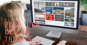 A person viewing a computer screen displaying a webpage with the title ‘2024 Web Design Trends’ in bold pink letters. The screen shows various website design elements including images of cities and landscapes, menu icons, and text sections.