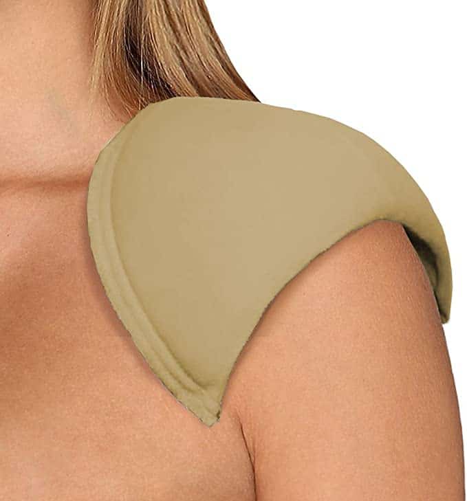 Close up of a beige colored shoulder pad on a persons shoulder This description highlights the smooth curved shape of the shoulder pad and its visible seam 📸