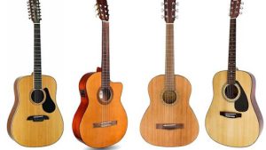 Four acoustic guitars showcasing different designs and wood finishes.