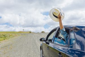 A family on a scenic road trip in California, with children looking out the car windows at the stunning landscapes. The image embodies the joy of exploring California's best routes for young adventurers. #best car trips