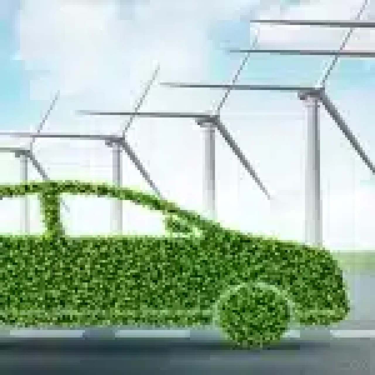 Green car made of foliage on a road with wind turbines in the background, symbolizing eco-friendly and sustainable transportation.