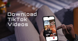 A person holding a smartphone with the TikTok app open, displaying a video with an overlay text “Download TikTok Videos.