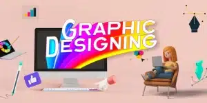 A vibrant graphic design themed image featuring a large monitor displaying the words ‘GRAPHIC DESIGNING’ in bold, colorful letters with a rainbow trail. Various design elements such as a paint palette, pen tool, and geometric shapes float around the scene. A character sits relaxed in an armchair with a laptop on their lap, next to a like button and megaphone.