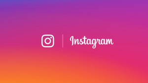 Instagram logo with brand name on a vibrant pink and orange gradient background.
