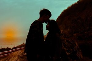 Love Advice : A love psychic surrounded by mystical symbols and tarot cards, providing guidance to a curious seeker of romantic insights.