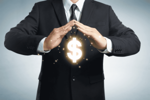 Financial Literacy for Small Business Owners: An entrepreneur working on financial statements with a calculator and laptop.