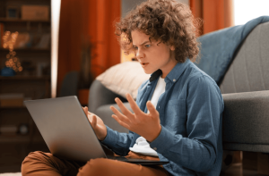 An online moderator monitoring a community forum on a computer screen, representing the concept of navigating the boundaries of online moderation.