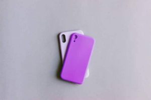 razor phone 2 cases - Two smartphone cases, one white and one vibrant purple, lying on a plain grey background.