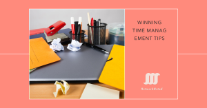 A cluttered desk with office supplies, including pens, crumpled paper, folders, and a laptop, illustrating the need for effective time management.