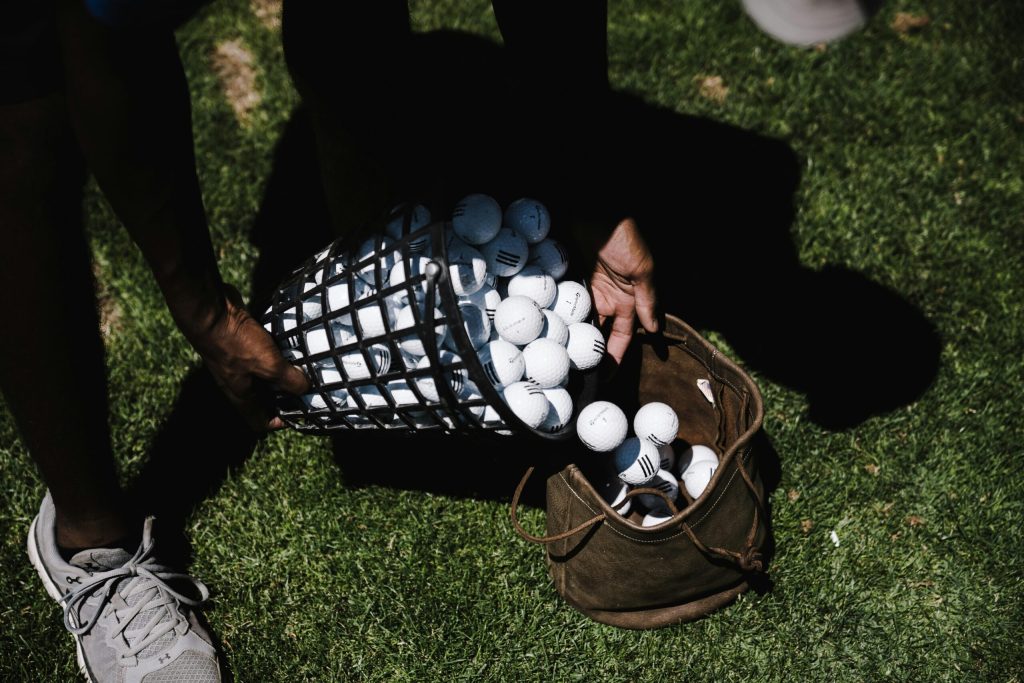 A golfer holding a custom golf ball, ready to tee off