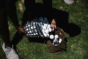 A golfer holding a custom golf ball, ready to tee off