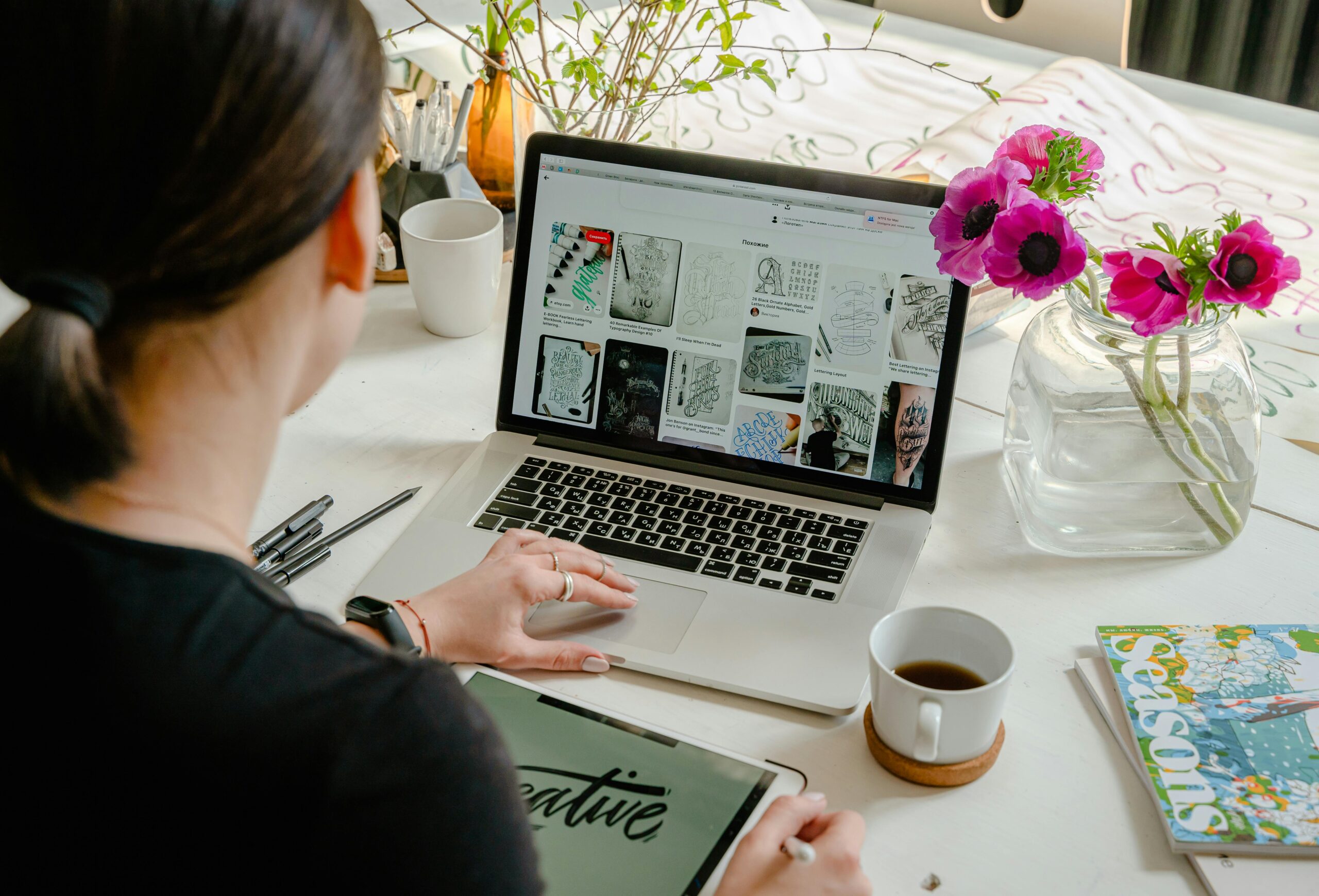 Person checking website security on a laptop in a home office setup with coffee and flowers. #web safe check