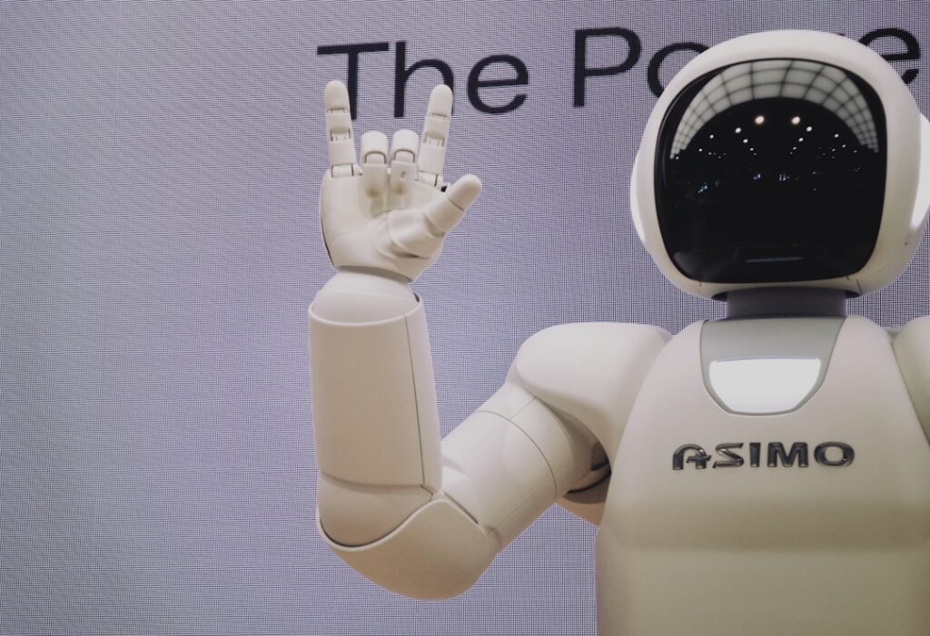 An Asimo robot doing the "I love you" sign in sign language.