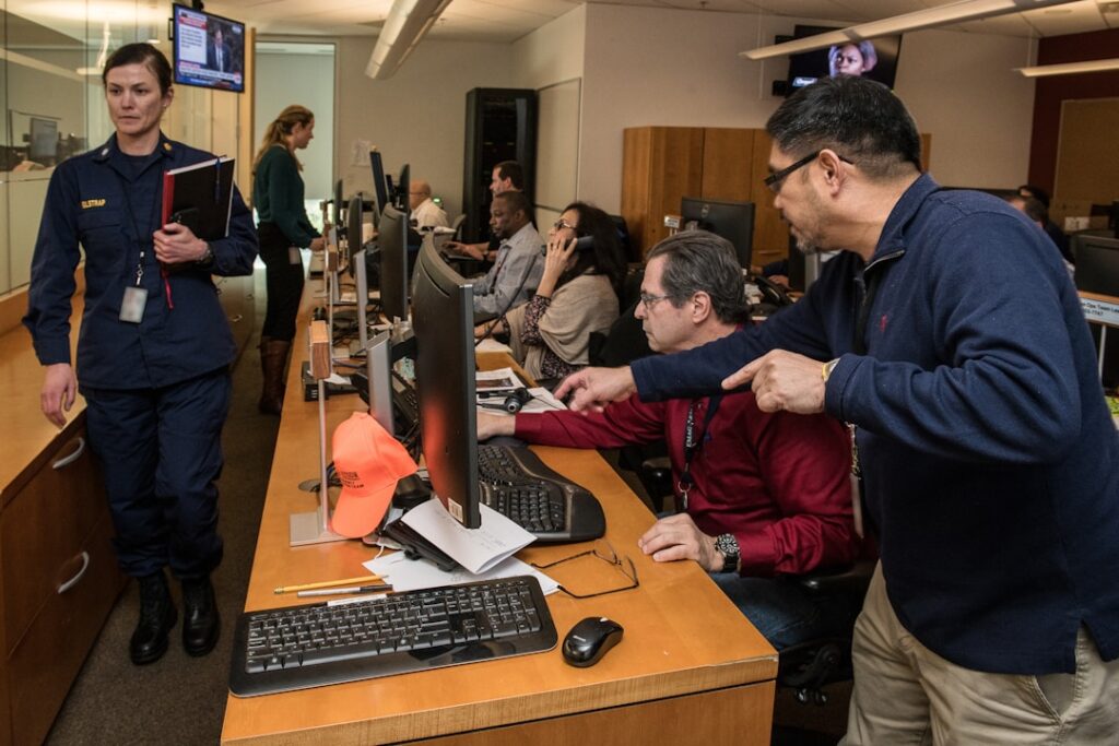 A group of people working diligently in their office, using AI knowledge management.