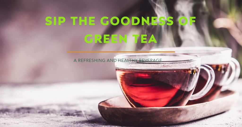 A clear glass cup of green tea with a handle on a wooden saucer The tea appears to be steaming indicating it is hot Overlaid text in bold white font reads SIP THE GOODNESS OF GREEN TEA followed by smaller text that states A REFRESHING AND HEALTHY BEVERAGE 🍵🌿