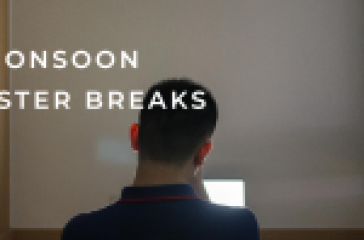 A person sitting at a desk focused on a laptop screen with ‘MONSOON SEMESTER BREAKS’ text overlay, symbolizing relaxation during academic holidays.