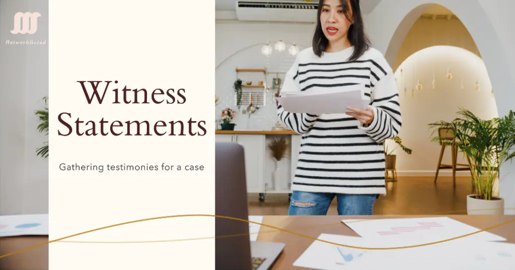 A person standing in a room holding a document titled ‘Witness Statements’ with documents spread out on a table, suggesting preparation for legal proceedings.