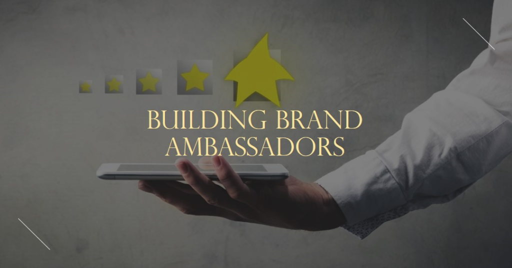 A persons hand holding a smartphone with an upward pointing green arrow and five stars above it symbolizing rating or improvement The phrase BUILDING BRAND AMBASSADORS is prominently displayed across the image suggesting a focus on enhancing brand reputation and customer loyalty The background is a plain grey surface with subtle textures