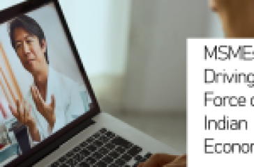 A laptop displaying an individual gesturing during a presentation with text ‘MSMEs: Driving Force of Indian Economy’ beside it.