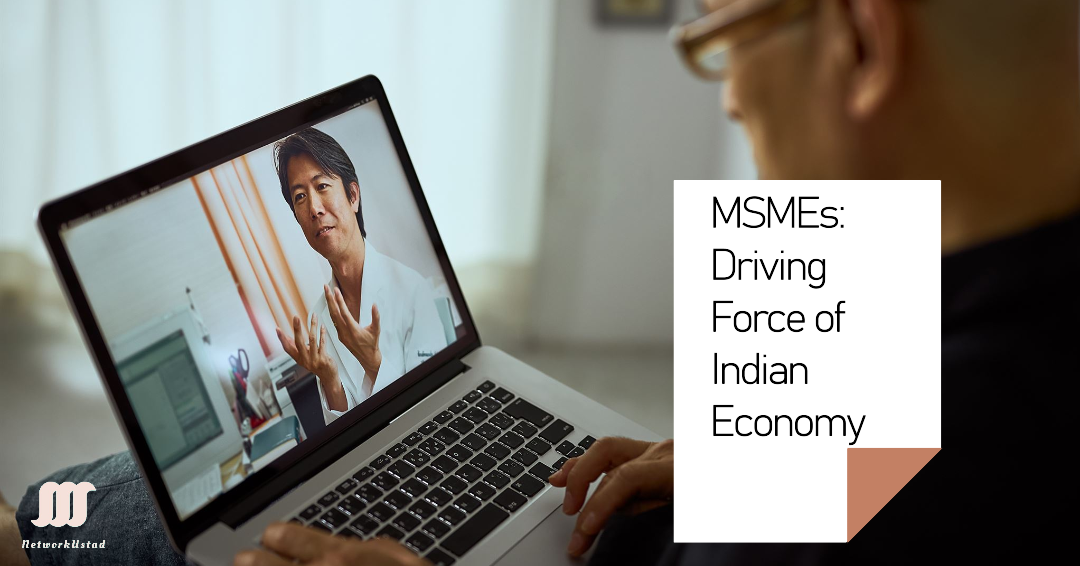 A laptop displaying an individual gesturing during a presentation with text ‘MSMEs: Driving Force of Indian Economy’ beside it.