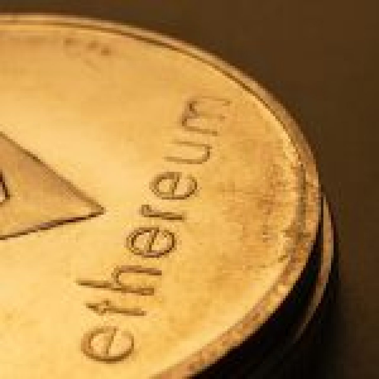 Close-up of an embossed Ethereum coin on a dark background.